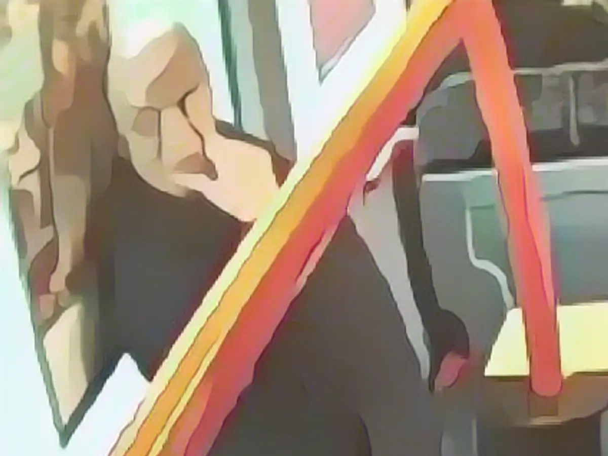 The suspect was casually standing on the bus, seemingly unfazed. The suspect was casually standing on the bus, seemingly unfazed.