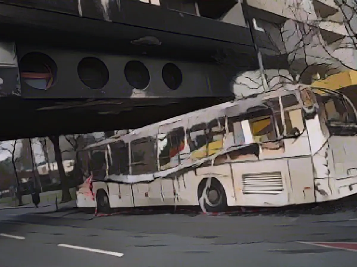 An empty coach leaves a trail of smoke after being set on fire New Year's Eve