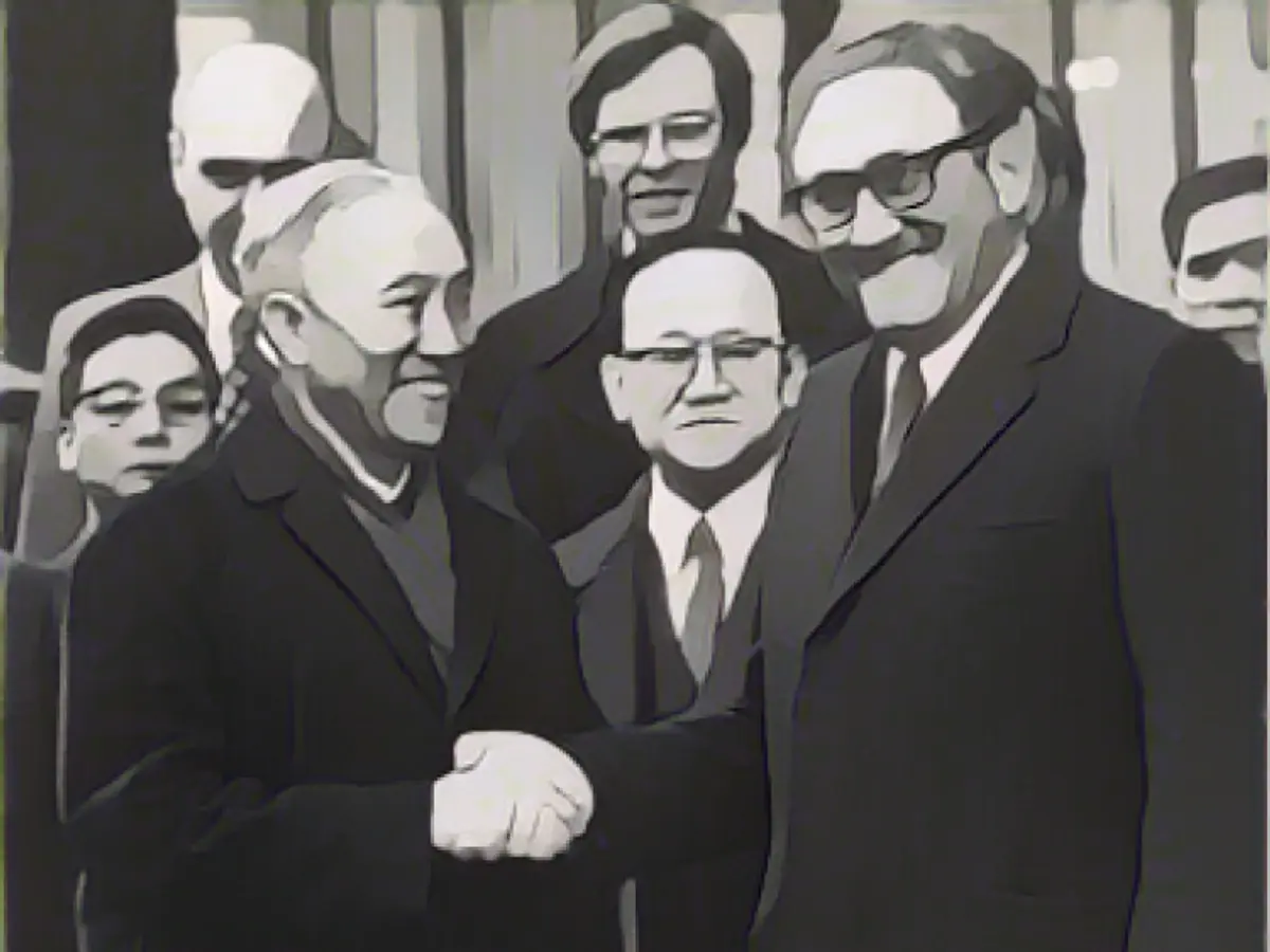 Kissinger with Le Duc Tho after the conclusion of the Vietnam negotiations in Paris on January 25, 1973.