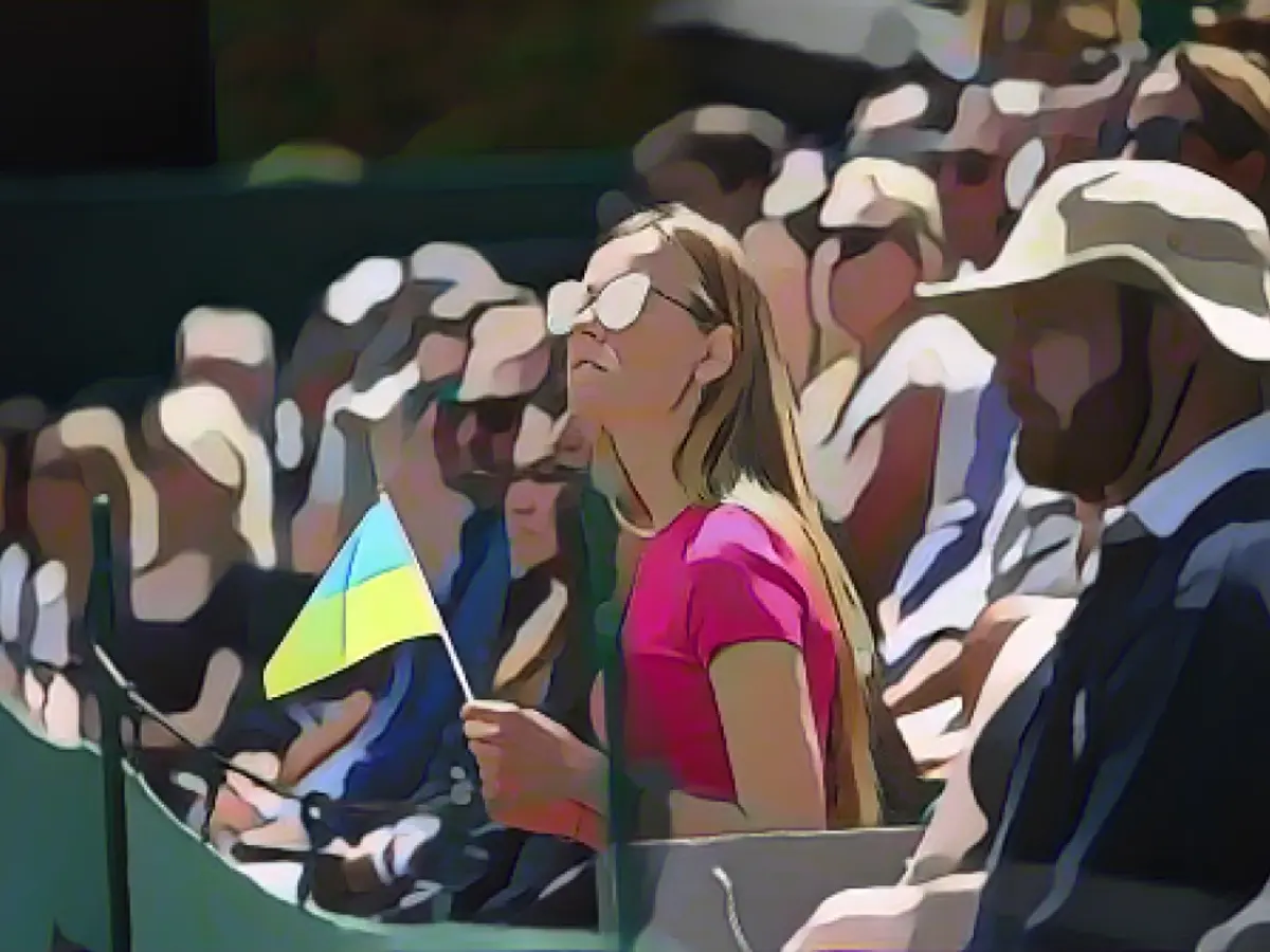 A spectator holds a Ukrainian flag at last year's Wimbledon.