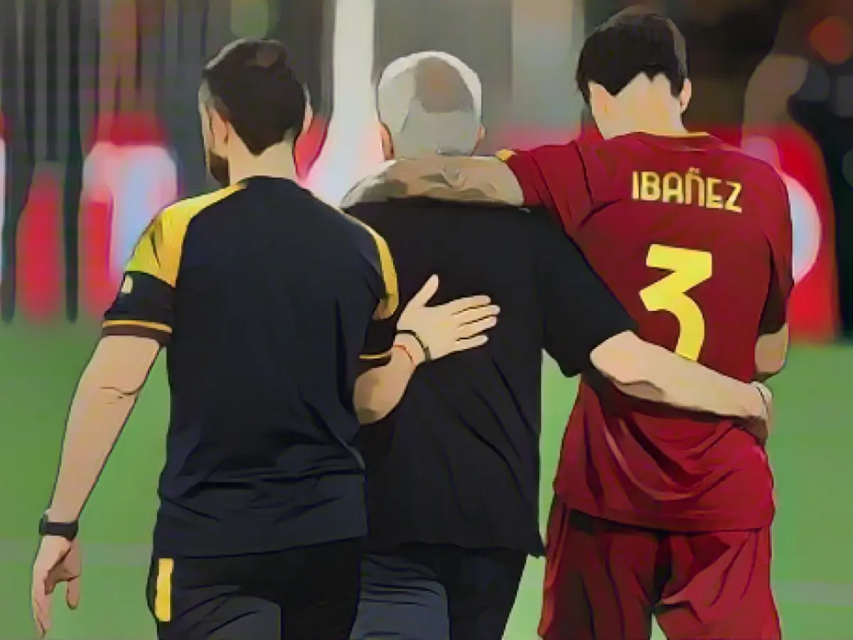 Mourinho (middle) embraces Roma defender Roger Ibañez (right) at the end of the Europa League final.