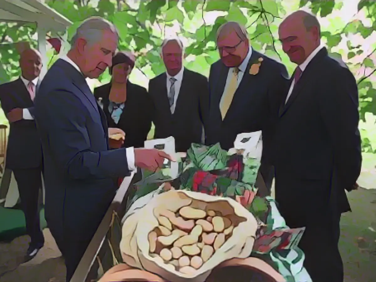 Prince Charles looks at produce during a reception in 2013 to celebrate the anniversary of Duchy Originals.
