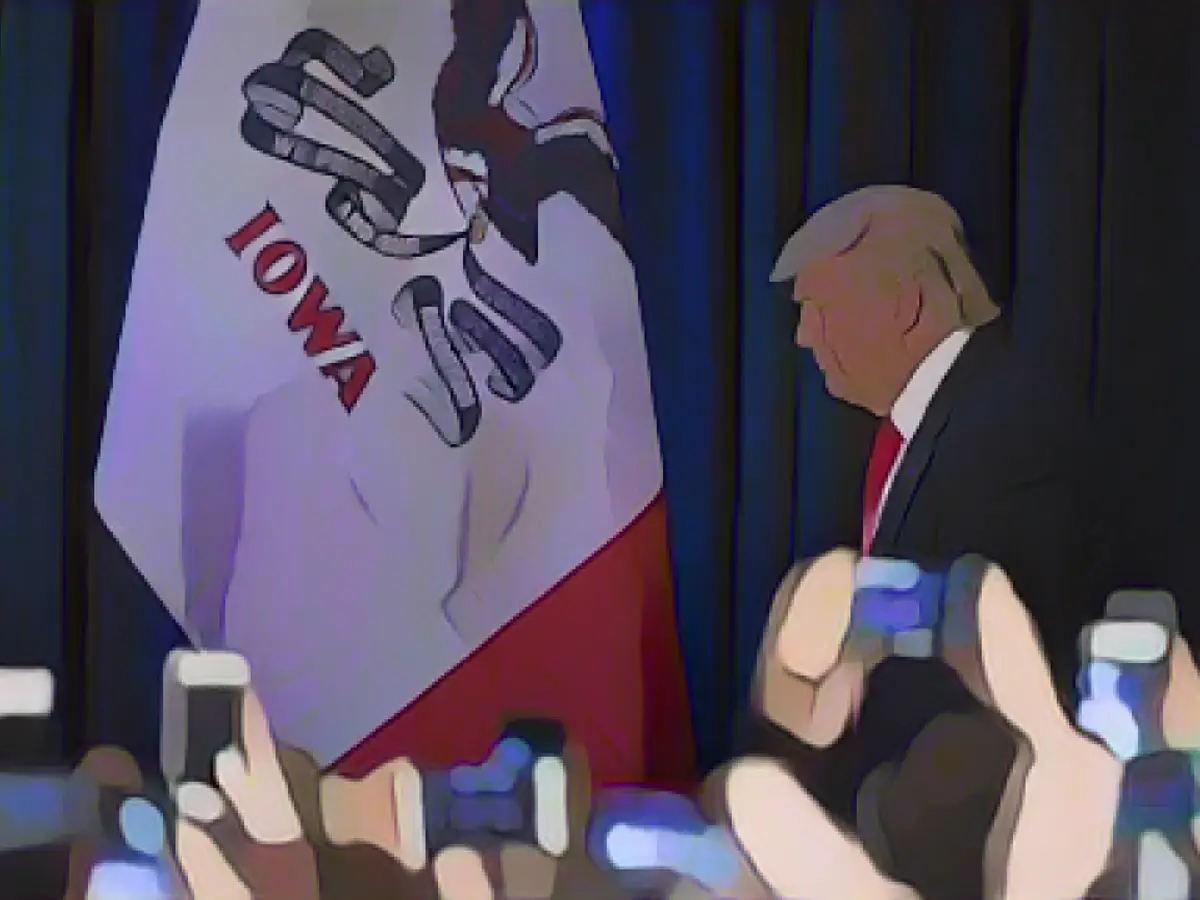 Donald Trump arrives to address his supporters after finishing second in the Iowa caucuses on February 1, 2016.