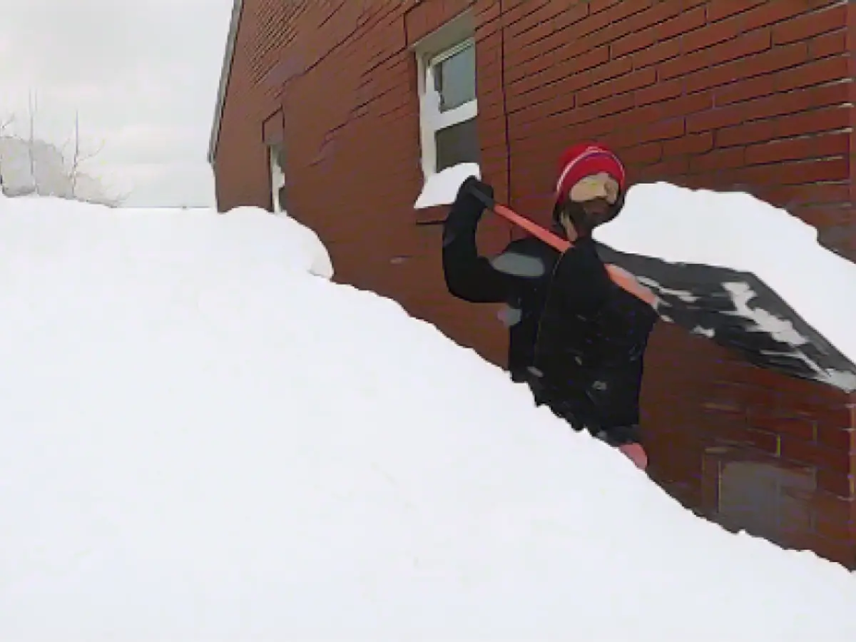 Patrick Harden clears snow from the roof of his car in Erie, Pennsylvania.