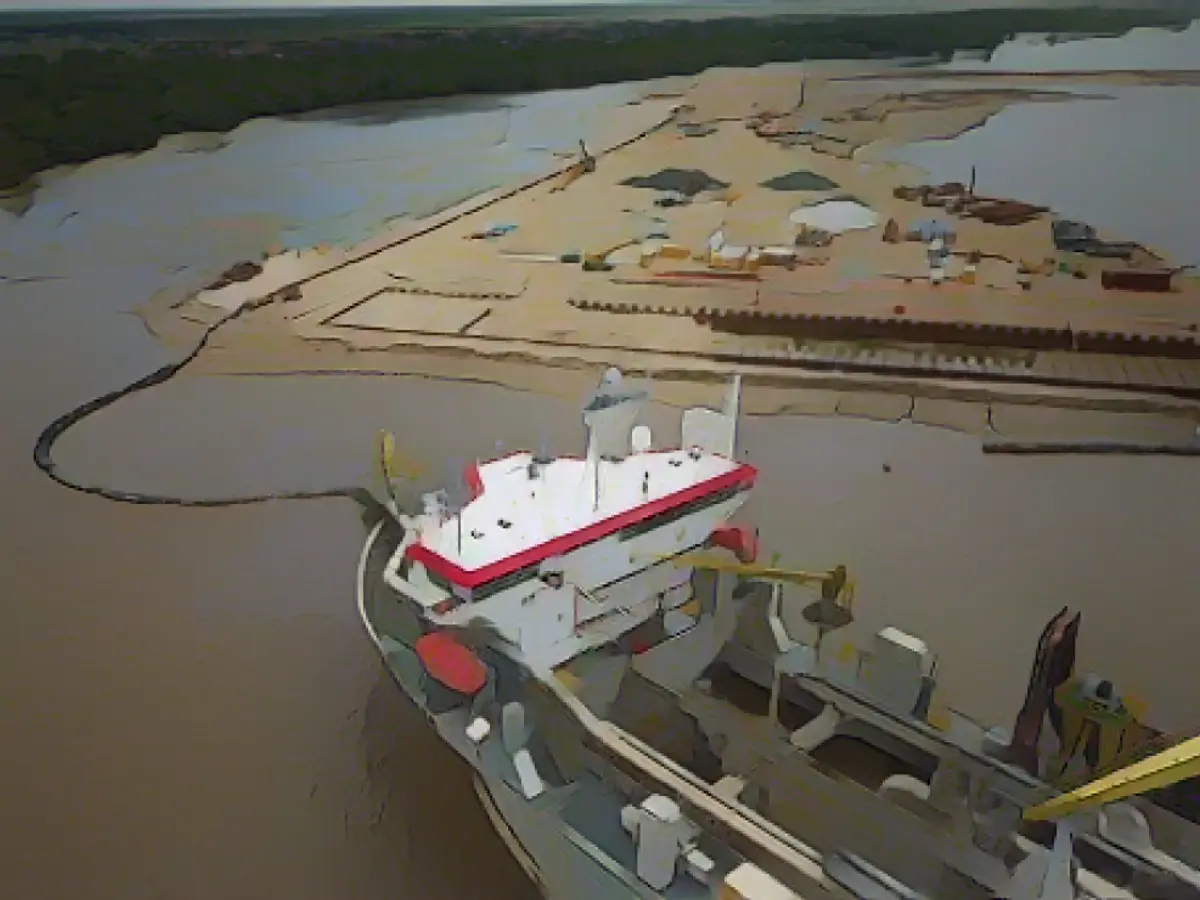 A ship creates an artificial island by extracting offshore sand to create a coastal port for offshore oil production at the mouth of the Demerara River in Georgetown, Guyana, on April 11, 2023. Guyana is on track to become the world’s highest per capita oil producer.