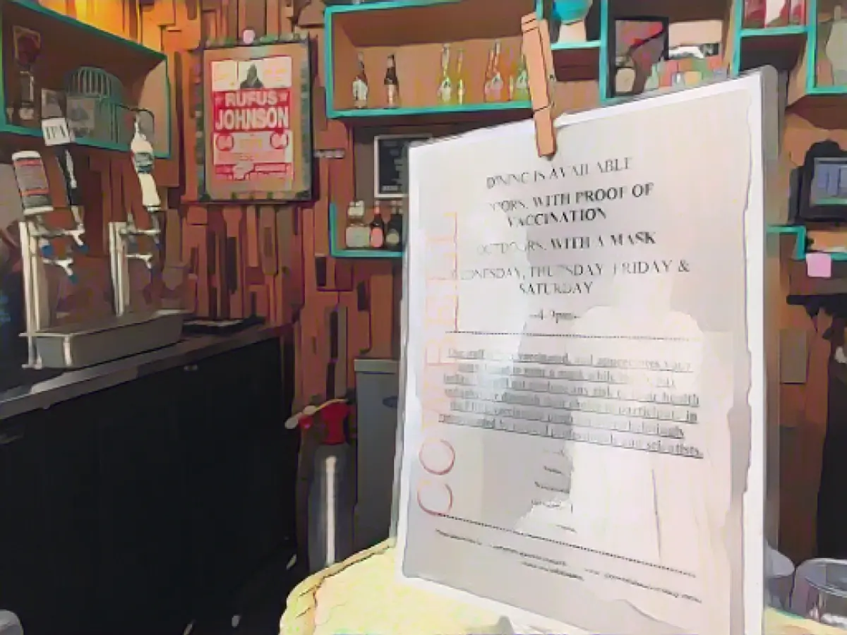 A sign at a Cowbell counter on Friday, Aug. 6, 2021, tells customers they can eat indoors if they have proof of vaccination against COVID-19.