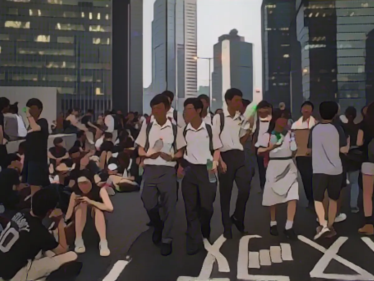 Students in uniforms distribute water in Admiralty.