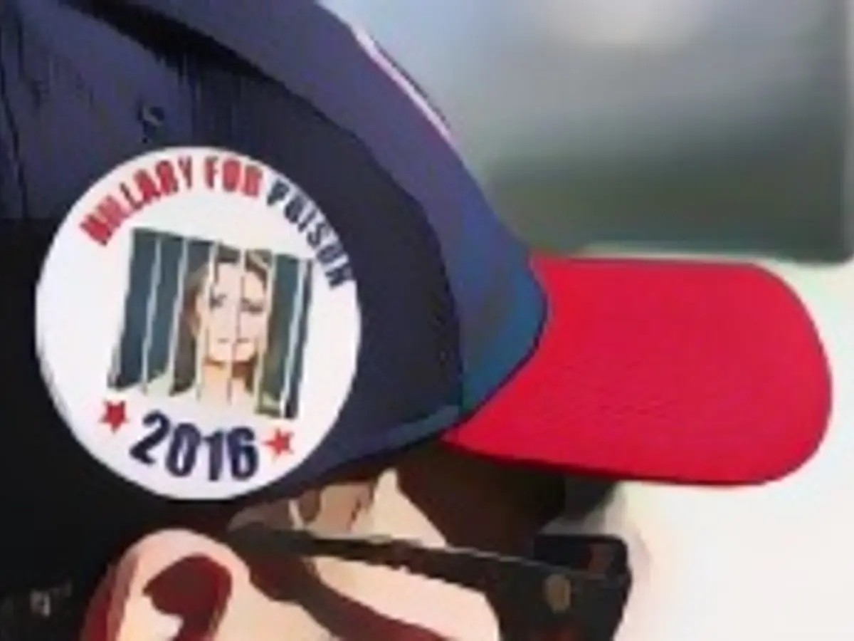 A Trump supporter wears an "Hillary Goes to Jail" button as he waits in line for a rally where Republican presidential candidate Donald Trump will speak on October 18, 2016, in Grand Junction, Colorado. A Trump supporter wears an "Hillary Goes to Jail" button as he waits in line for a rally where Republican presidential candidate Donald Trump will speak on October 18, 2016, in Grand Junction, Colorado.