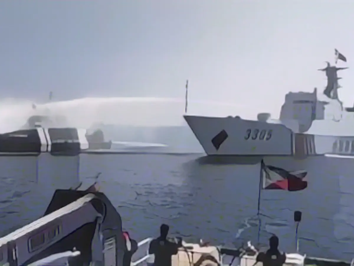 A Chinese ship fires water cannons at Philippine supply ships A Chinese ship fires water cannons at Philippine supply ships