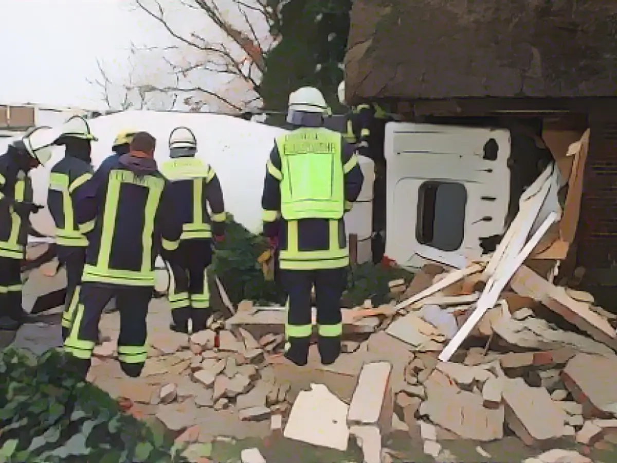 The aftermath of the accident, as seen by a drone, with firefighters assessing the scene Firefighters assess the damage done, a drone's perspective reveals the aftermath