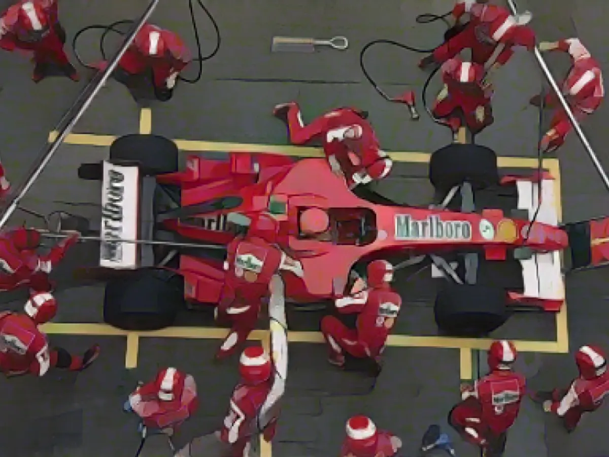 A equipa das boxes de Schumacher trabalha no seu carro durante o Grande Prémio da China de Fórmula 1 em Xangai, em 2006.