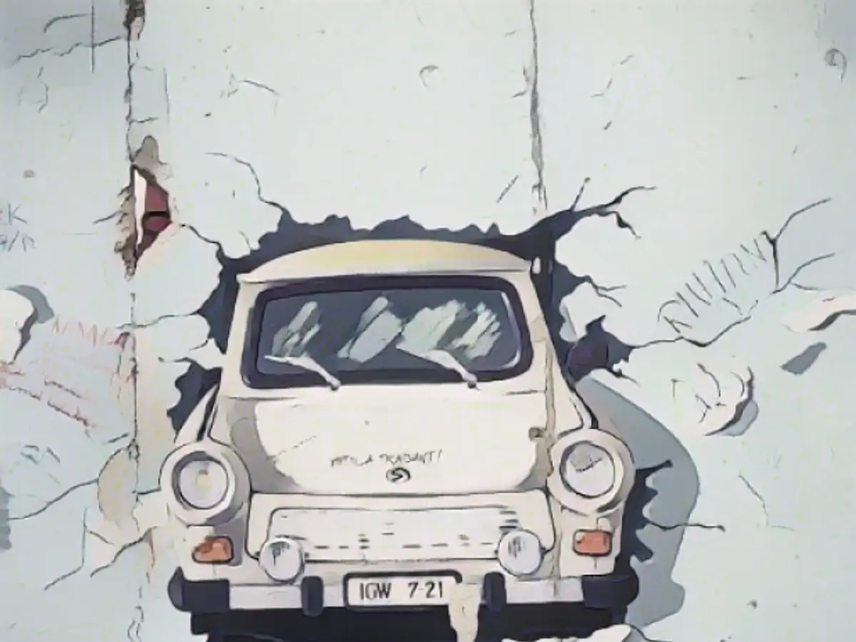 Una pintura de un Trabant atravesando un muro en el Berlín posterior a la unificación, agosto de 1993. La Fórmula E espera que la carrera del sábado sea otro momento decisivo para los coches eléctricos.