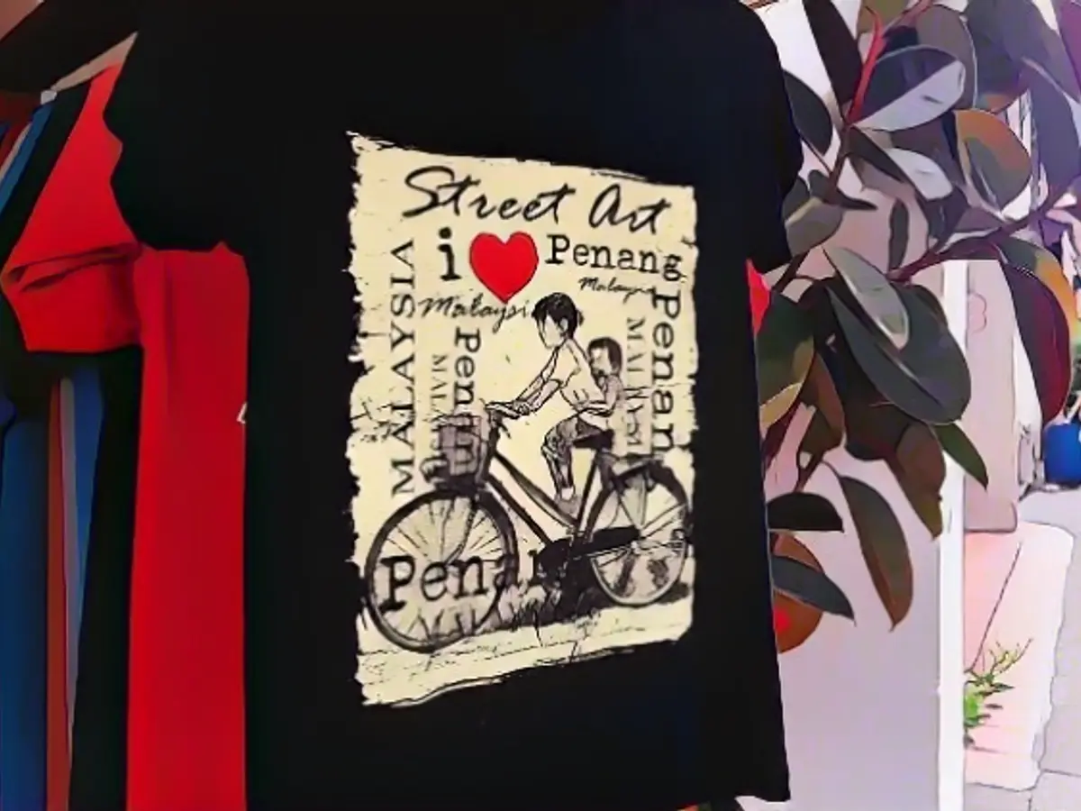 T-shirts with street art from Penang are on sale in a store.