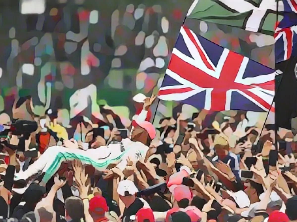 Lewis Hamilton, Silverstone'daki galibiyetinin ardından kendisine hayranlık duyan hayranlarıyla birlikte kalabalık sörfü yaptı.