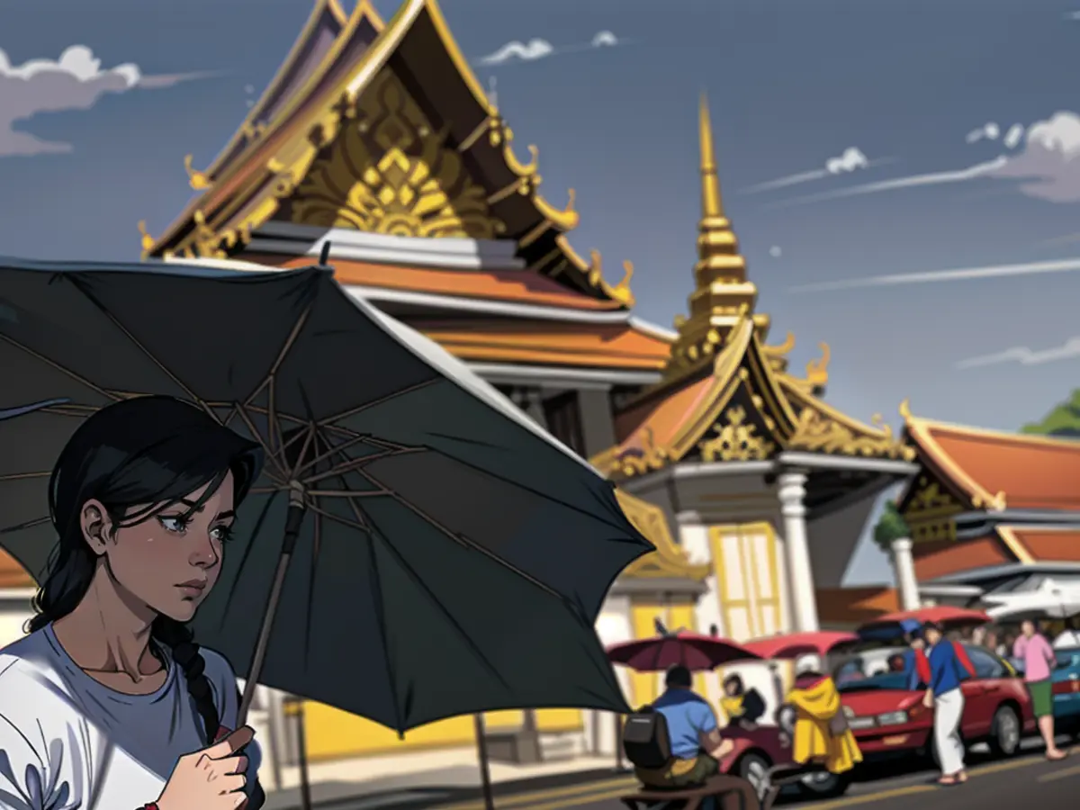 TOPSHOT - Tourists shield themselves from the sun with umbrellas to combat the heat outside of Wat Pho Buddhist temple in Bangkok on April 1, 2024. (Photo by Lillian SUWANRUMPHA / AFP) (Photo by LILLIAN SUWANRUMPHA/AFP via Getty Images)