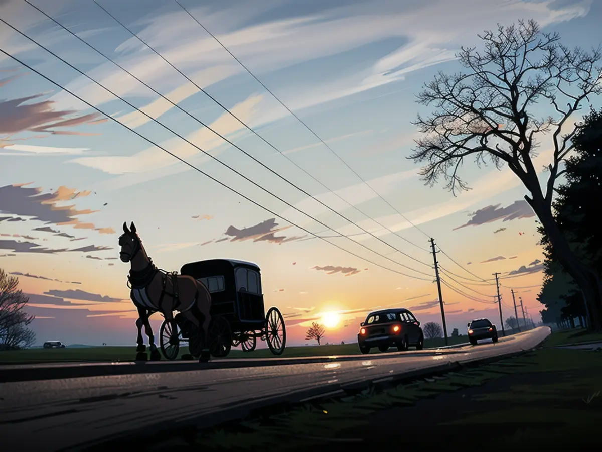 An Amish buggy shares the road with automobiles in Strasburg, Pennsylvania.