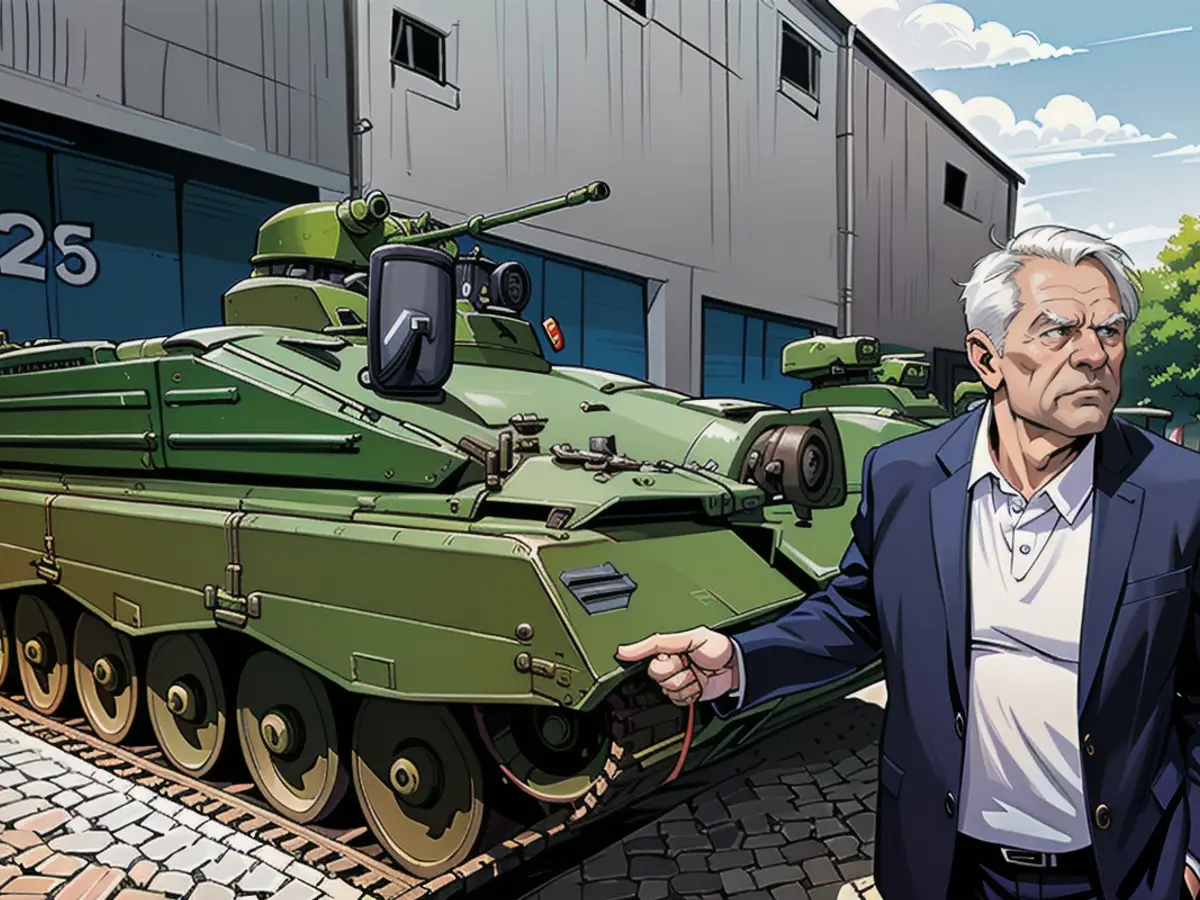 Rheinmetall boss Armin Papperger in front of a refurbished Marder infantry fighting vehicle