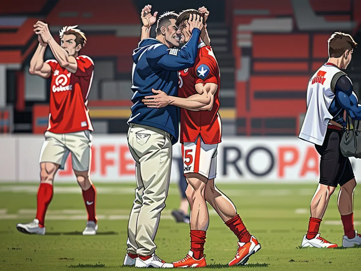 Tearful rescue: Robin Gosens (right) celebrates relegation with Union manager Oliver Ruhnert