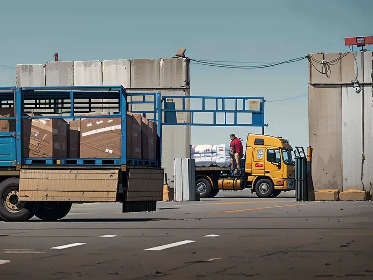 Trucks carrying aid move through security inspections at the Kerem Shalom crossing in March.