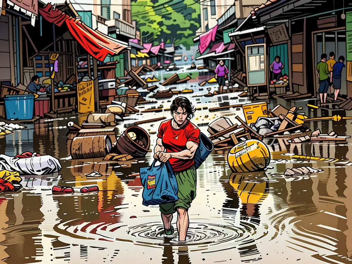 Un abitante di un villaggio cammina su strade fangose mentre le piogge torrenziali causano inondazioni il 19 giugno 2024 a Meizhou, nella provincia cinese di Guangdong.