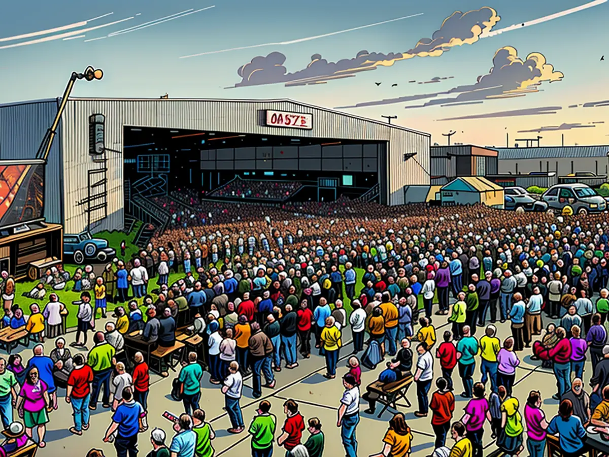 People listen to Harris speak at Detroit Metropolitan Wayne County Airport on August 7, 2024, in Romulus, Michigan, where screens were set up for those who couldn't see the stage.