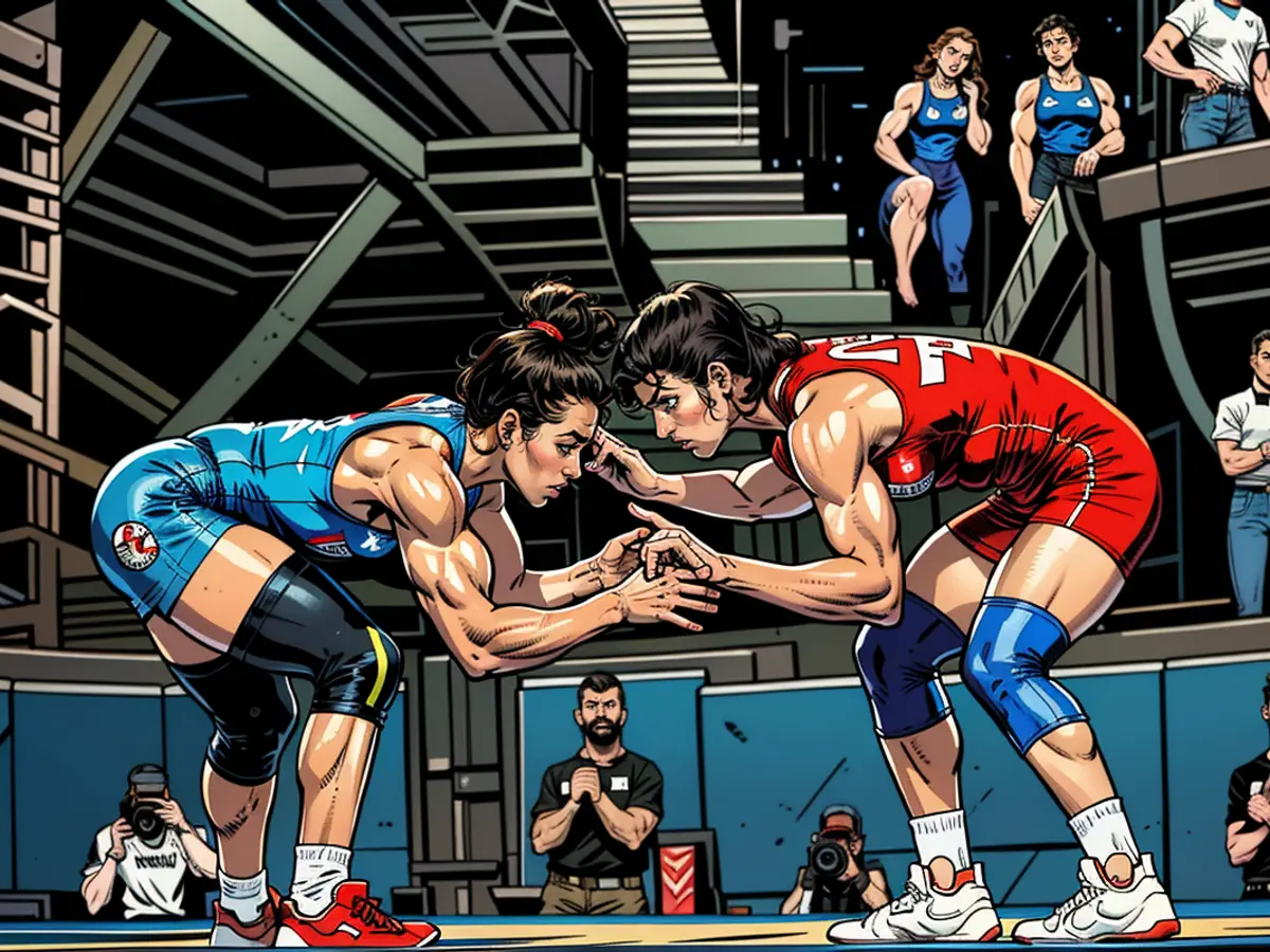 India's Vinesh Phogat (red) takes on Cuba's Yusneylis Guzman Lopez during the Olympic women's freestyle 50kg wrestling semifinal at the Champ de Mars Arena on August 6, 2024 in Paris.