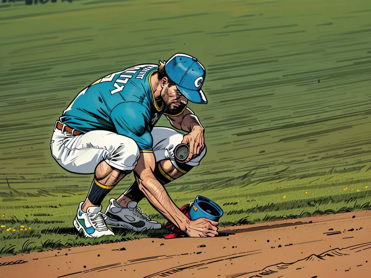 Oakland A's player Jacob Wilson gathers soil from the playing surface following the last match at Oakland Coliseum