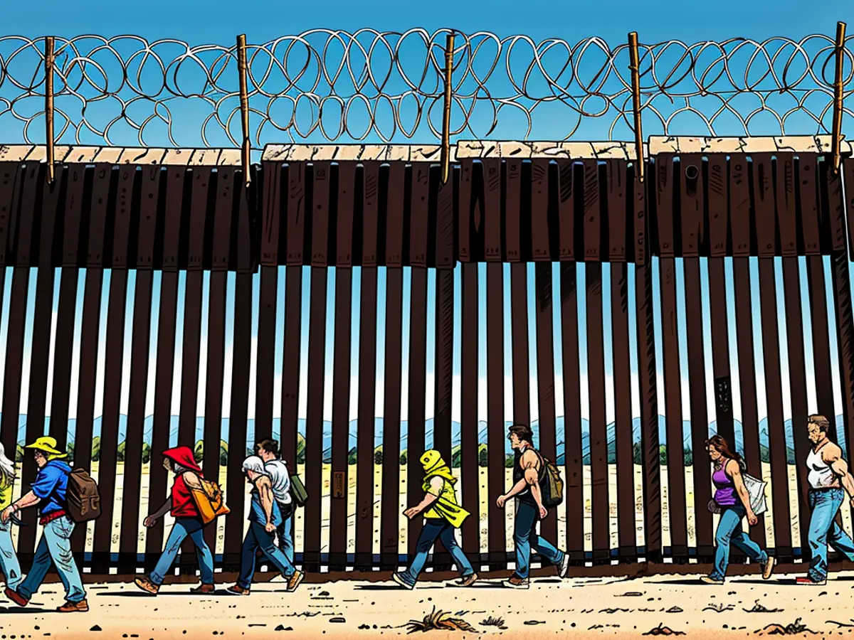 Migrants traverse the American side of the border fence in Jacumba Hot Springs, California, following their journey from Mexico on June 5th.